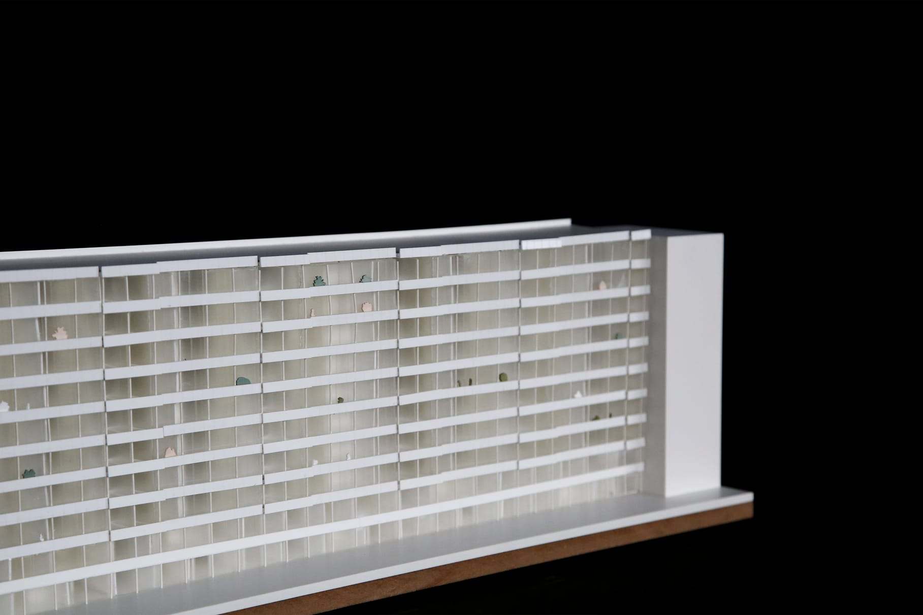 The long white facade of the model against a black background