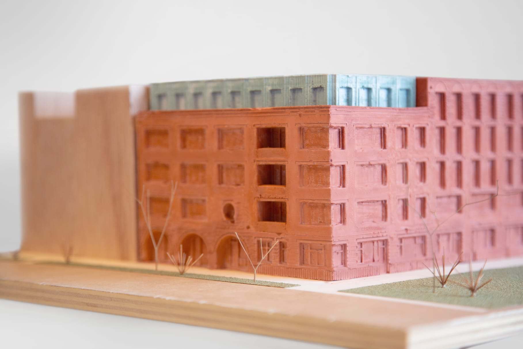 Pink and red rendered facades meeting at the corner
