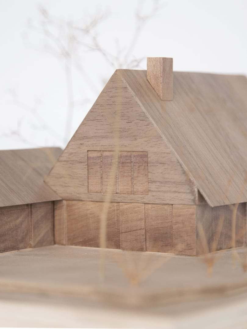 Close-up of the roof and chimney of the walnut model, with the grain running through the volume
