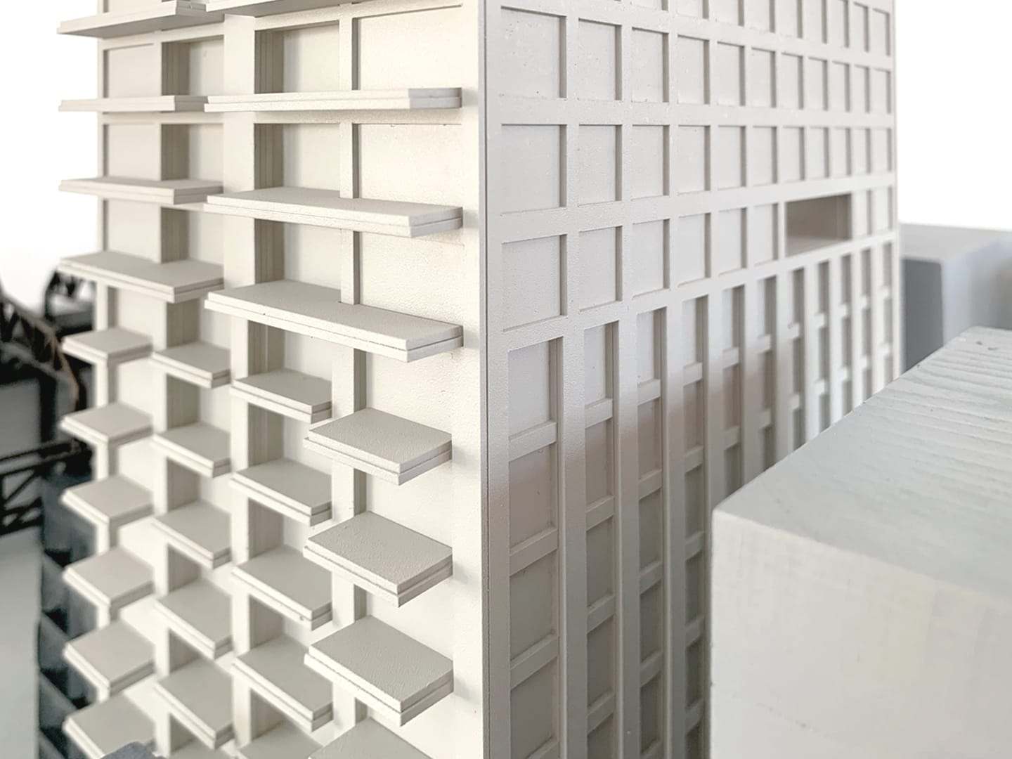 Close-up of the De Draaier model's gridded facade with projecting balcony slabs