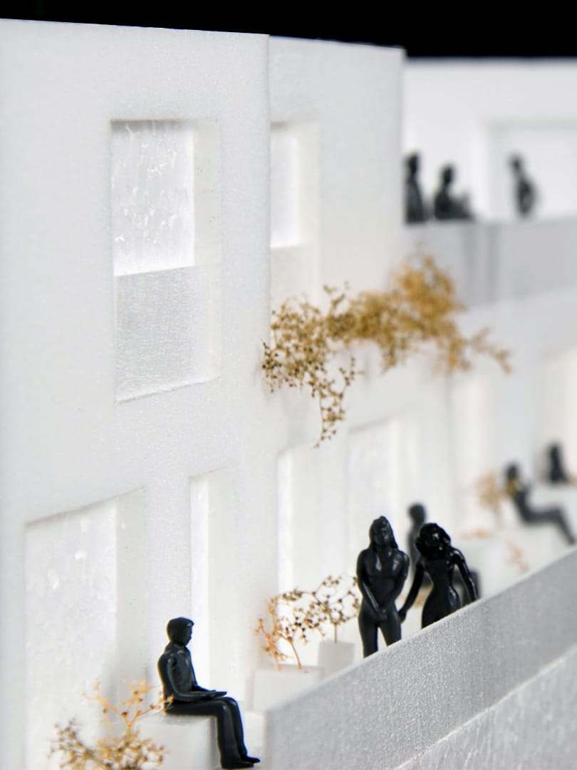 Figures standing and sitting along the terrace edge