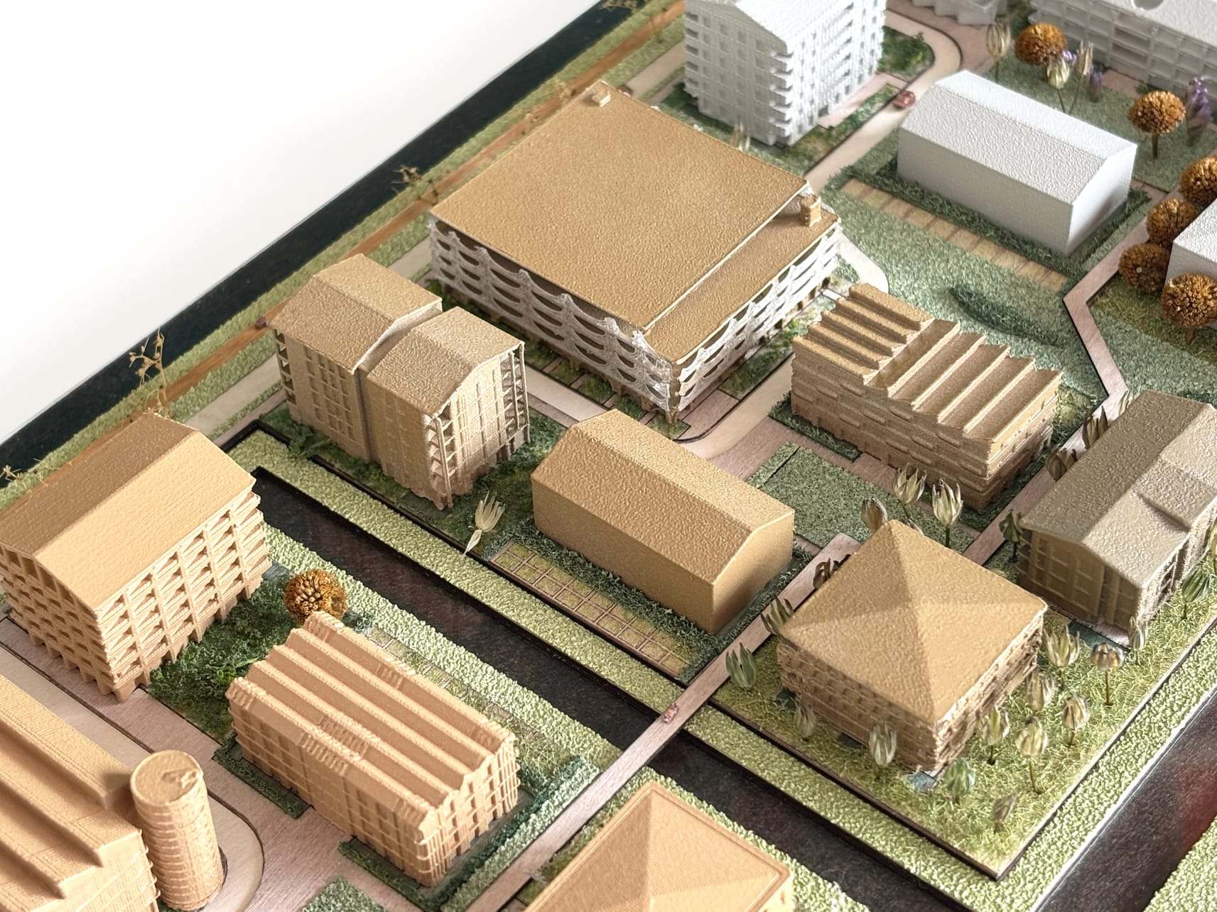 Timber-coloured blocks and pitched roofs along the green paths