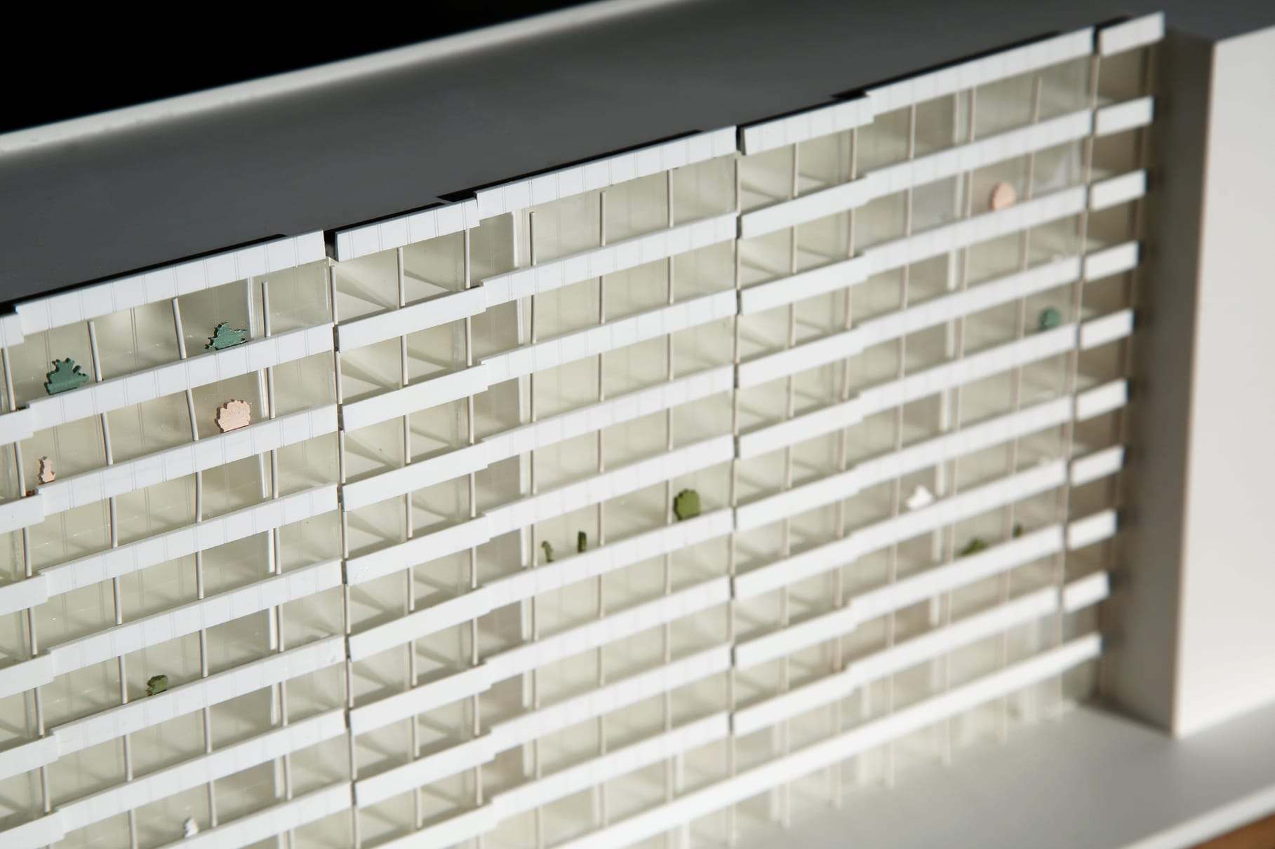 Detail of the cast acrylic facade, with the railings meeting the outward bend of the glass