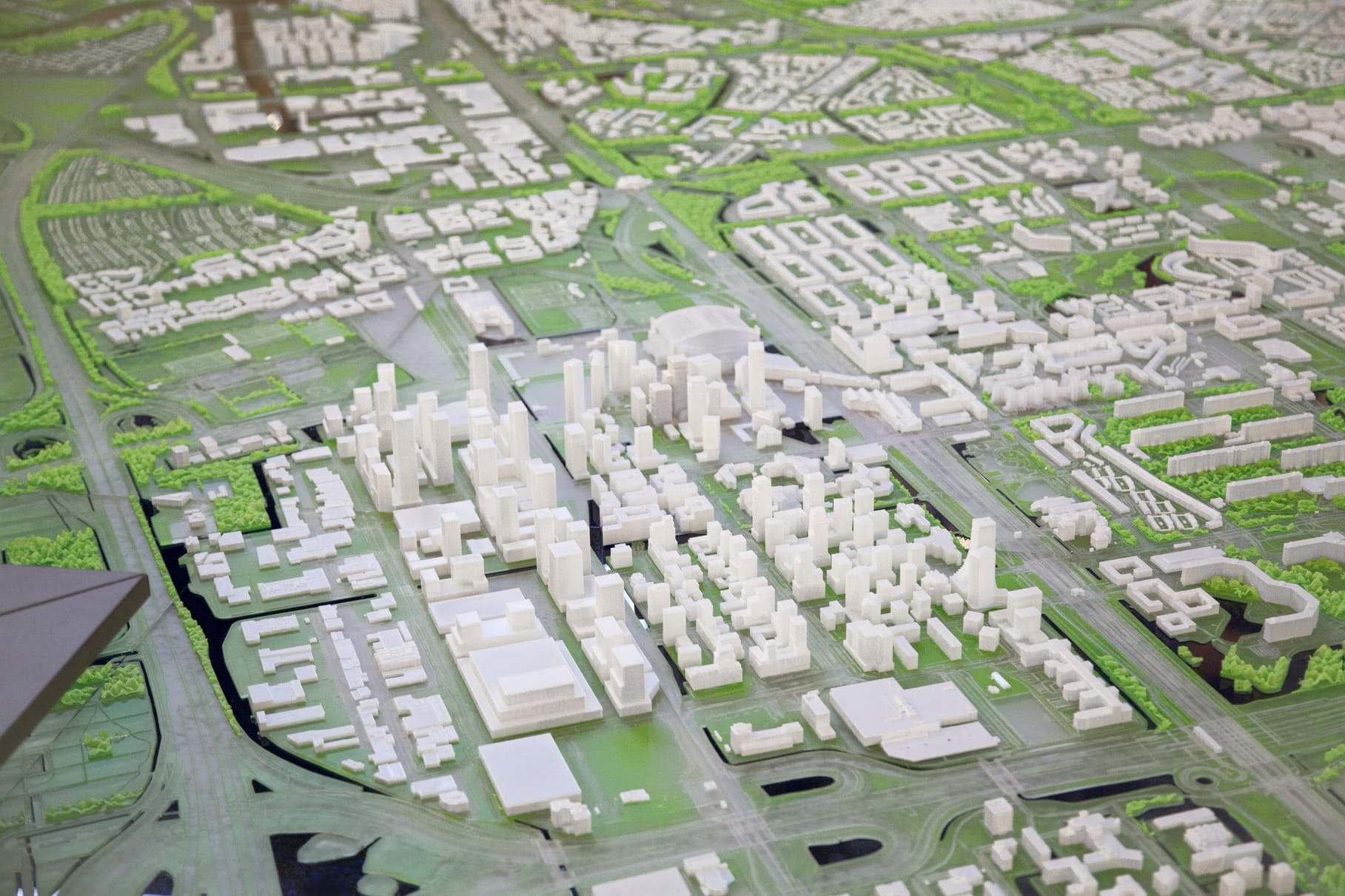 Aerial view of the 750 years of Amsterdam city model, with the city blocks in white on green