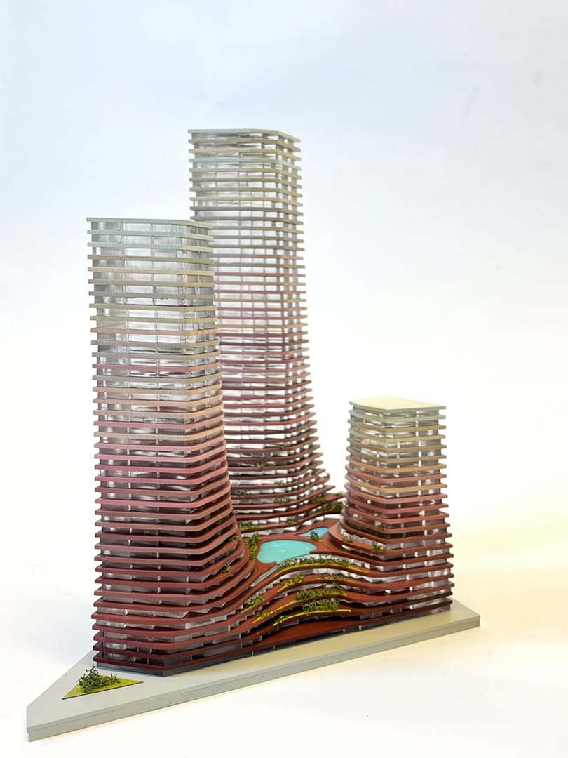 Three towers rising from the plinth, burgundy at the base to off-white at the top