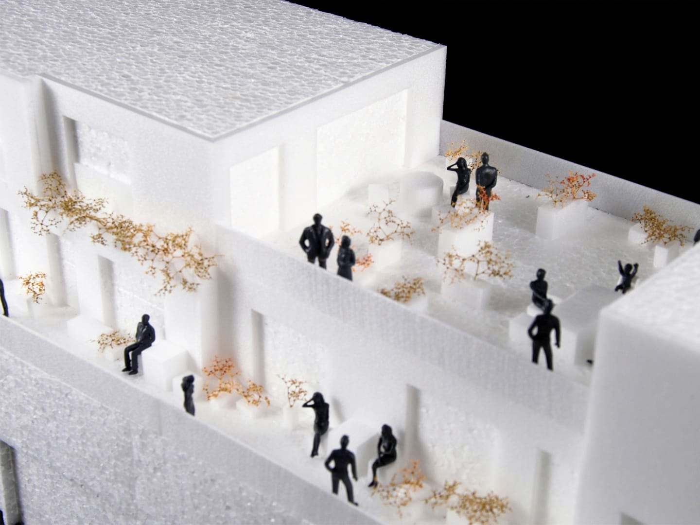 The terraces and exterior galleries full of figures and greenery, from above