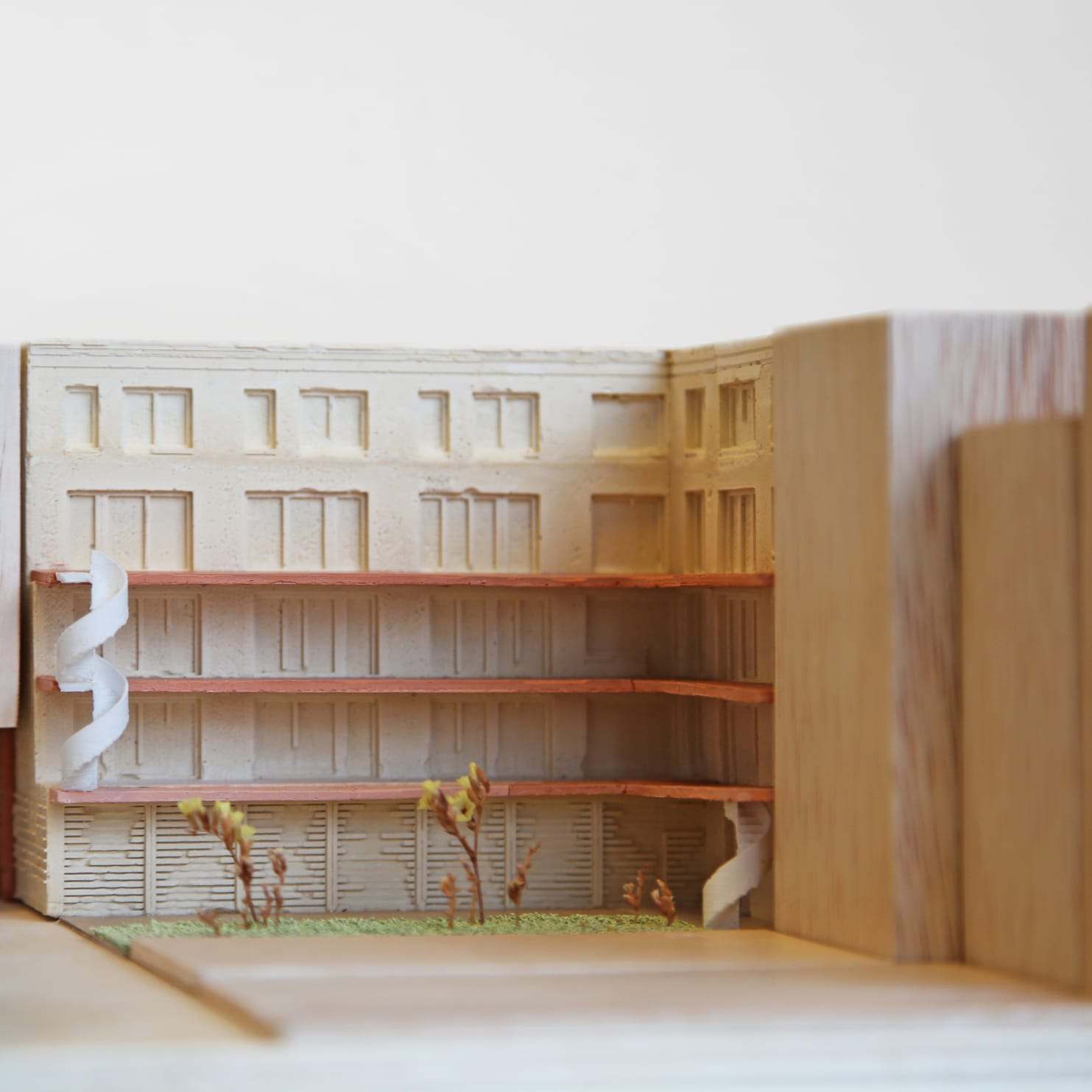 The pale inner facade with its stacked balcony decks