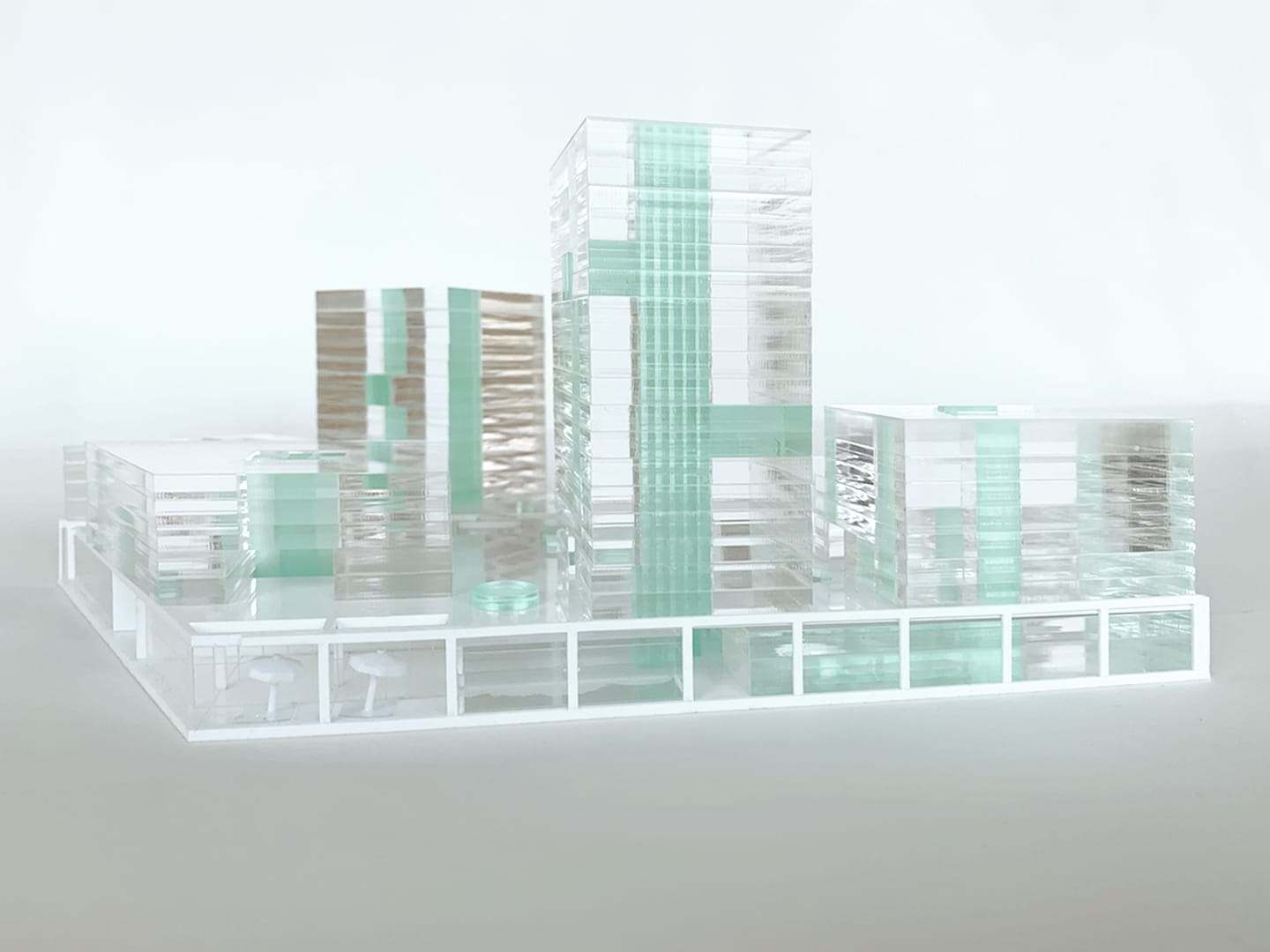 1:500 concept model of the Hamerkwartier: a white PVC grid with transparent and green acrylic towers