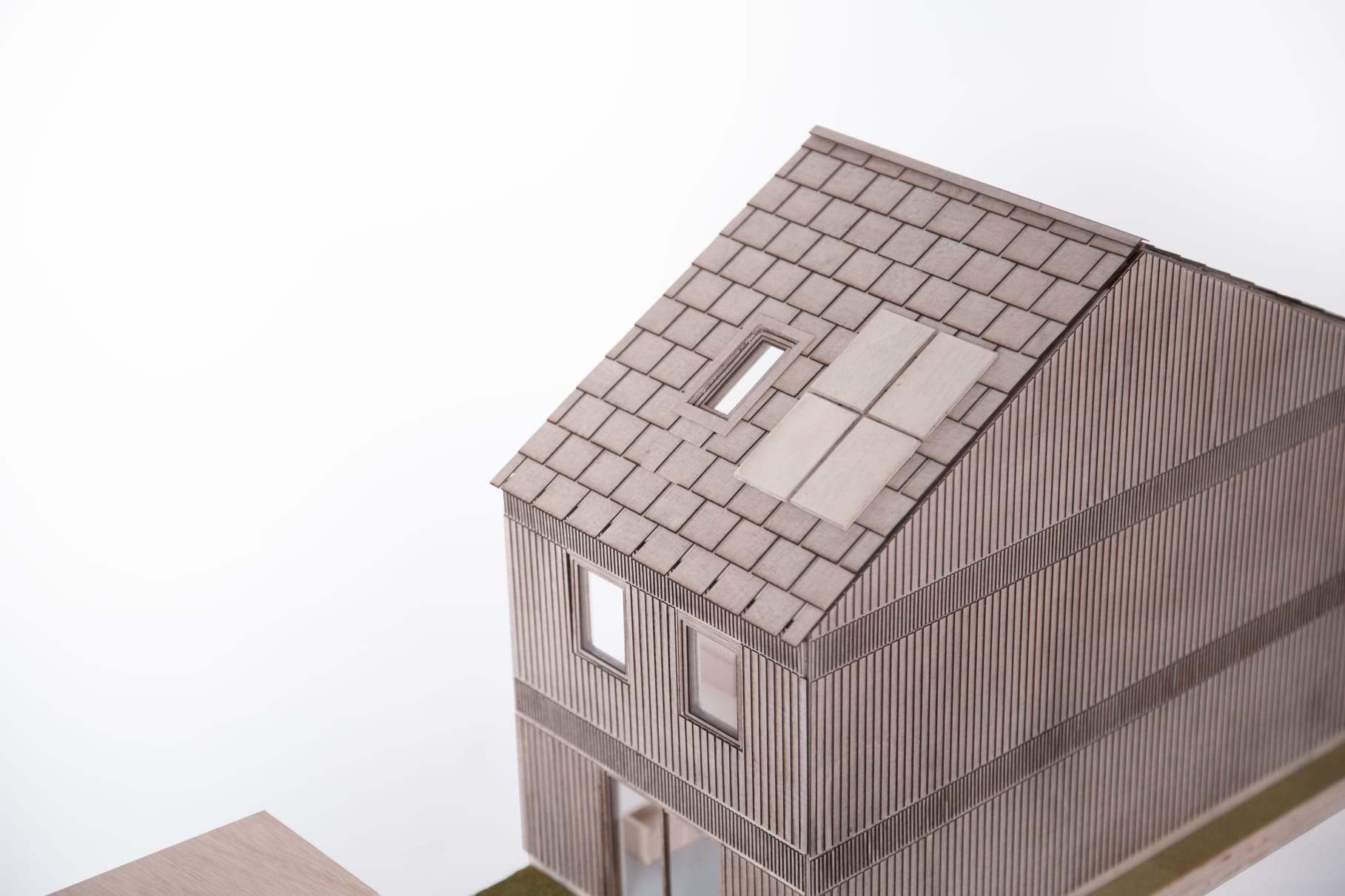 The closed volume, with its tiled roof and vertical timber cladding