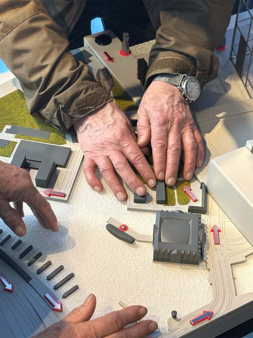 Hands exploring the site model by touch