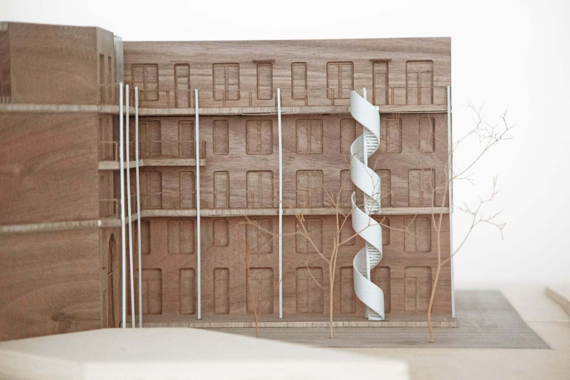 Facade close-up with the spiral stair and the slender poles