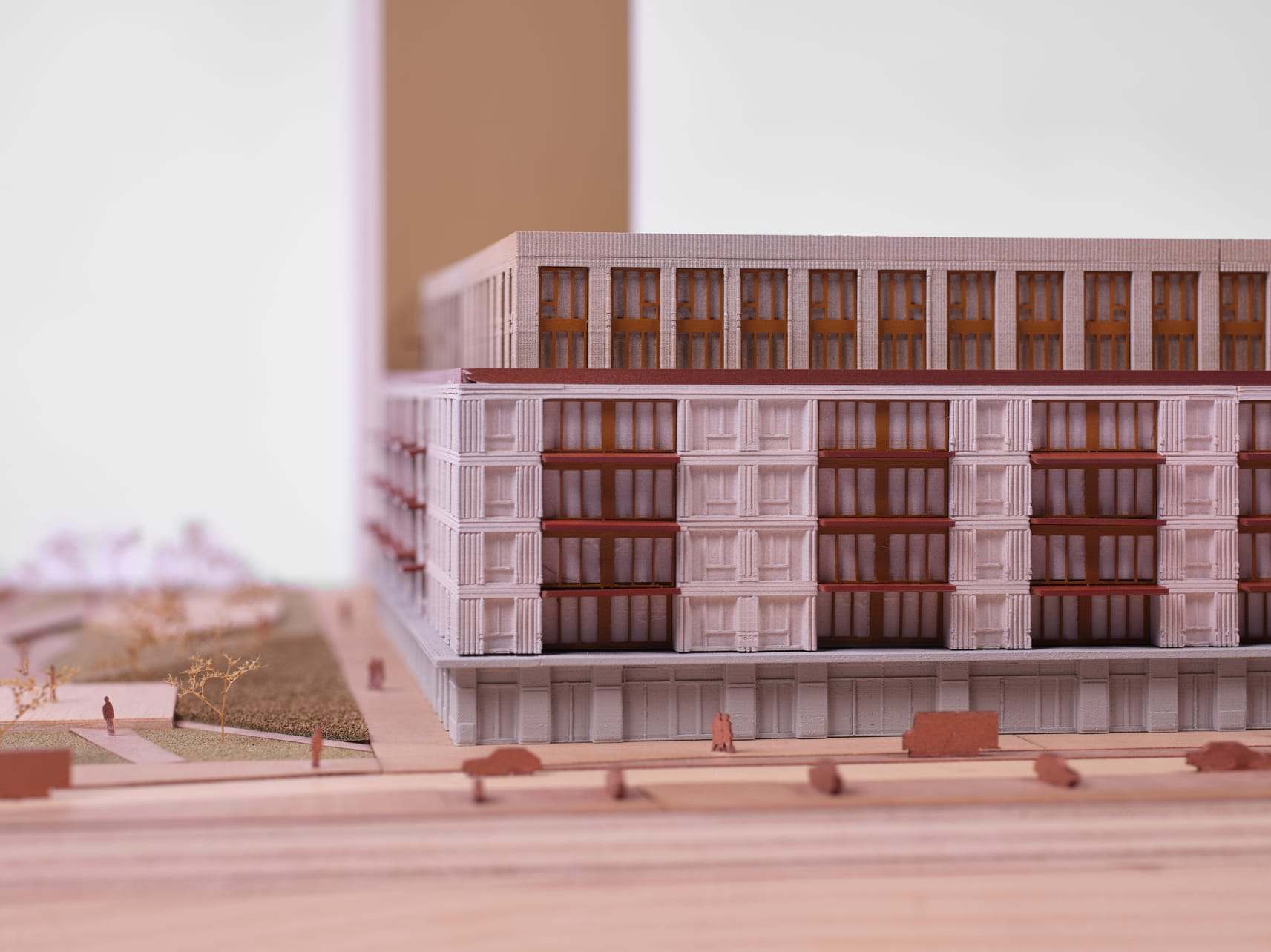 Close-up of the pale render facade and its regular window grid