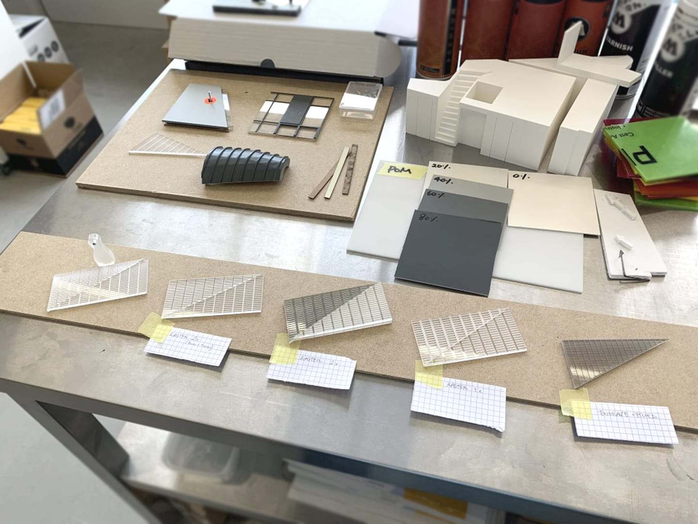Workbench with material samples and small acrylic test pieces for the ARCAM model