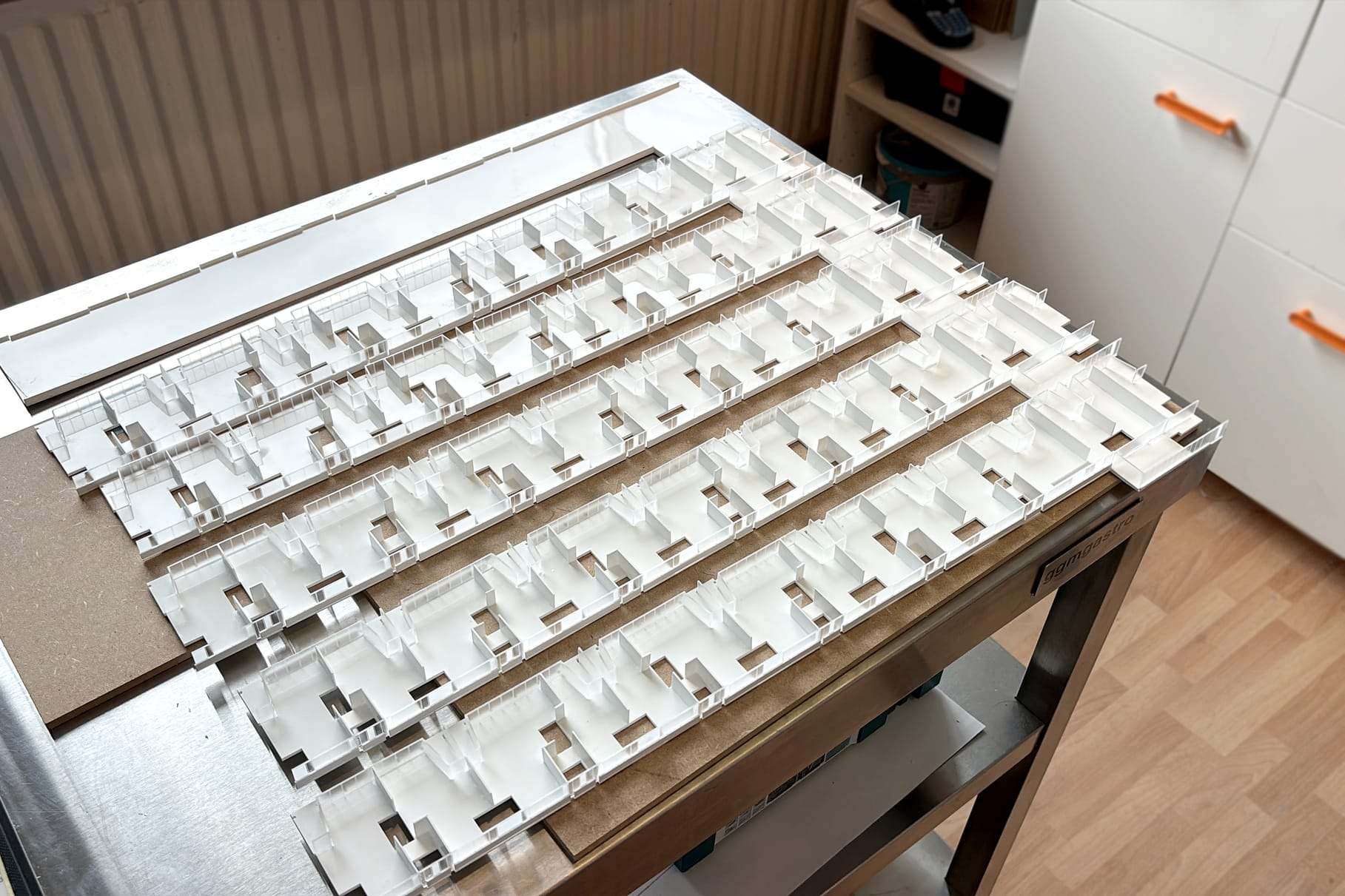 Rows of white facade elements for the Güterbahnhof model laid out on a table