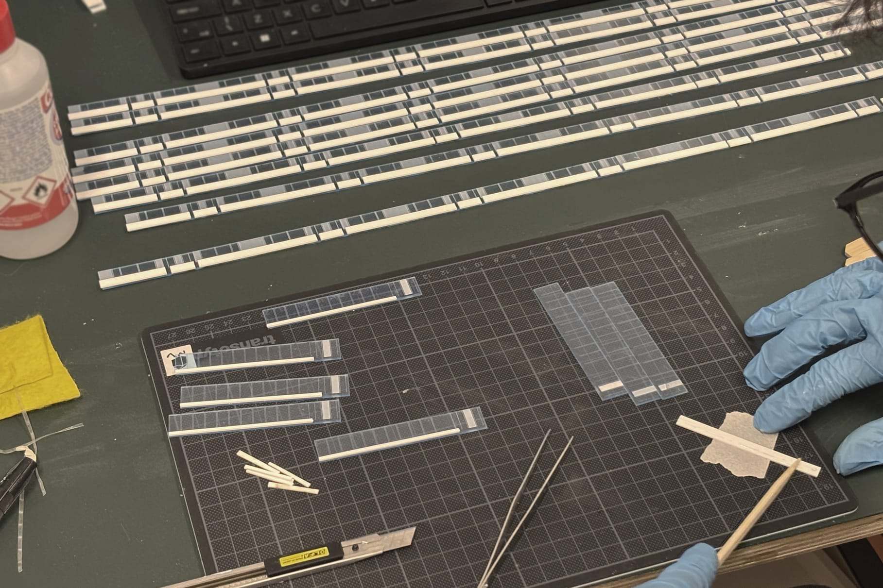 Cutting and assembling the thin white strips of the Güterbahnhof model on a cutting mat