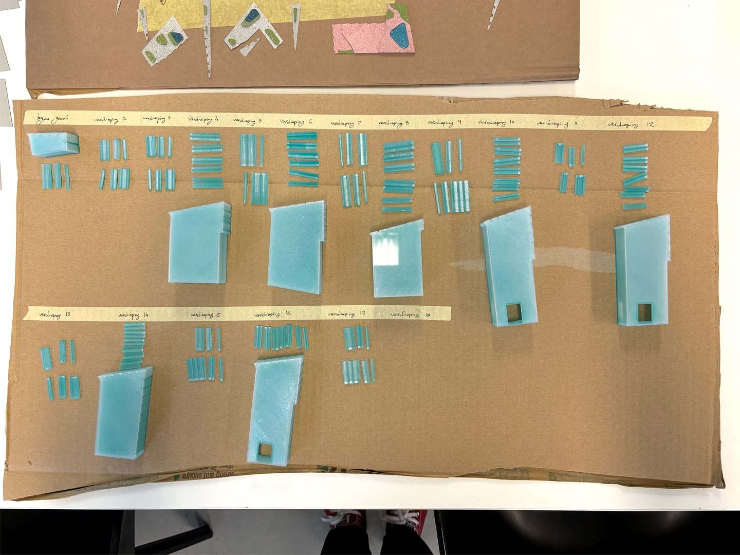 Blue glass facade parts sorted and labelled on cardboard