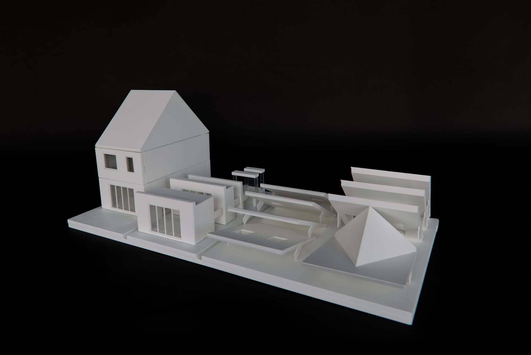 The full catalogue on its base plate, with the gabled house at the end of the row