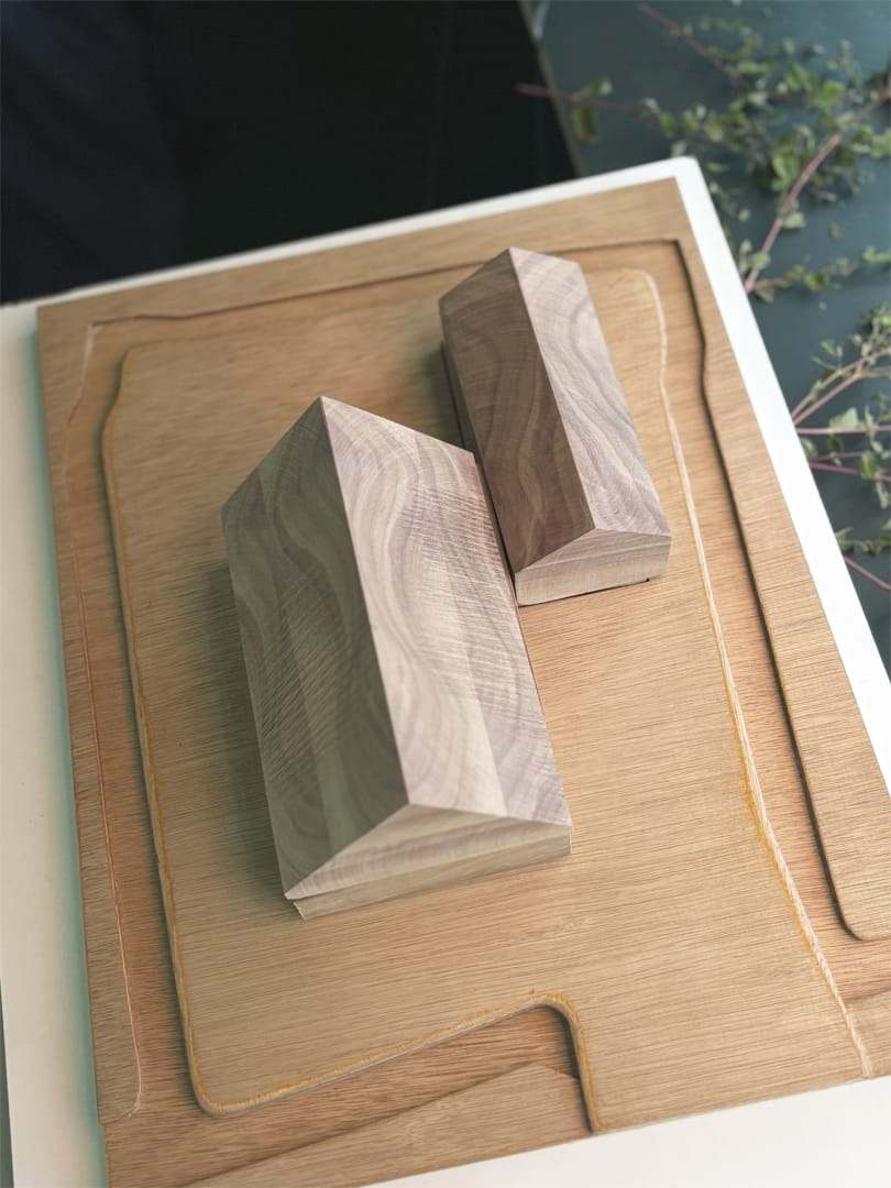 Two walnut volumes on a routed plywood site base