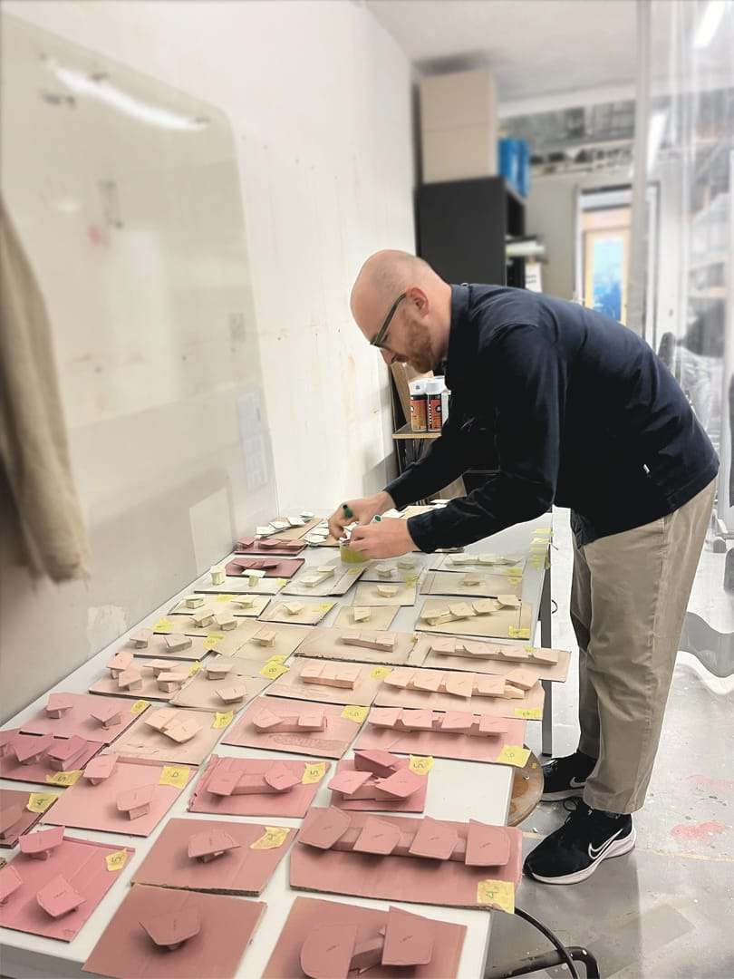 Laying out the painted slabs in their gradient on the workbench
