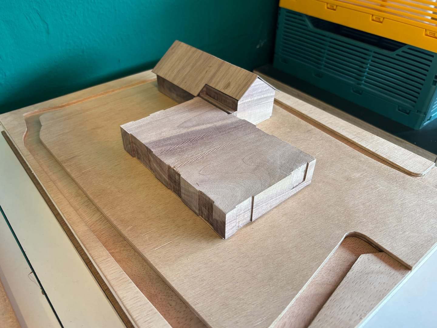 The Villa Voorwerf model in progress on its plywood base, with a green crate behind it