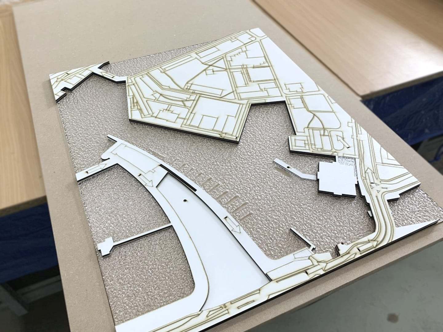 The cut-out site plan of the ARCAM model with roads and paths in white card