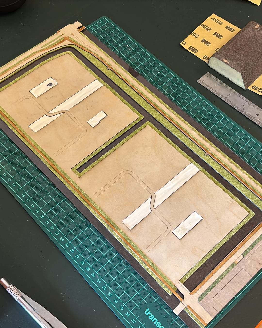 The base of the Lincolnpark model being cut from layered board on a cutting mat