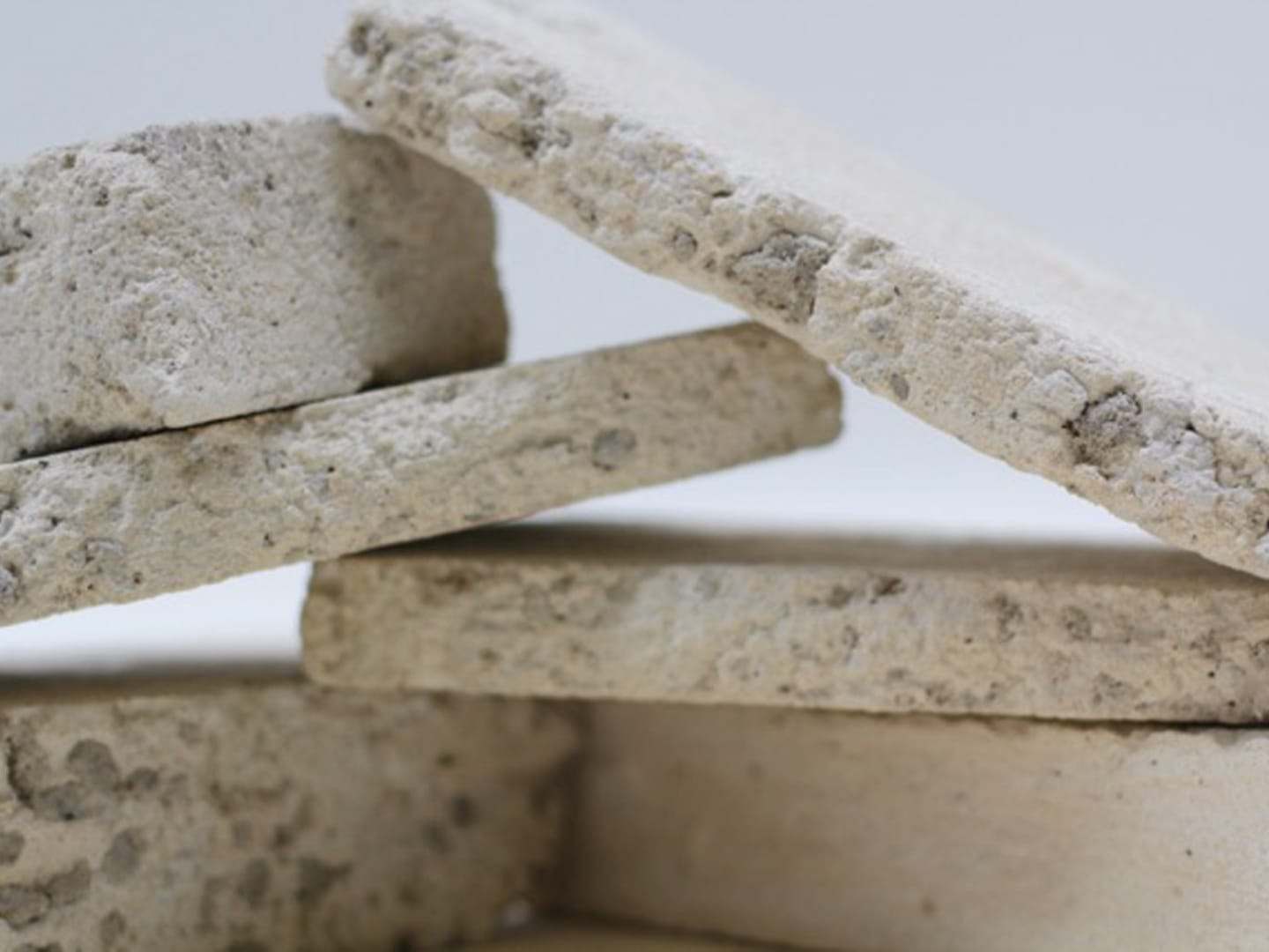 Stacked slabs of cast concrete, showing the porous surface