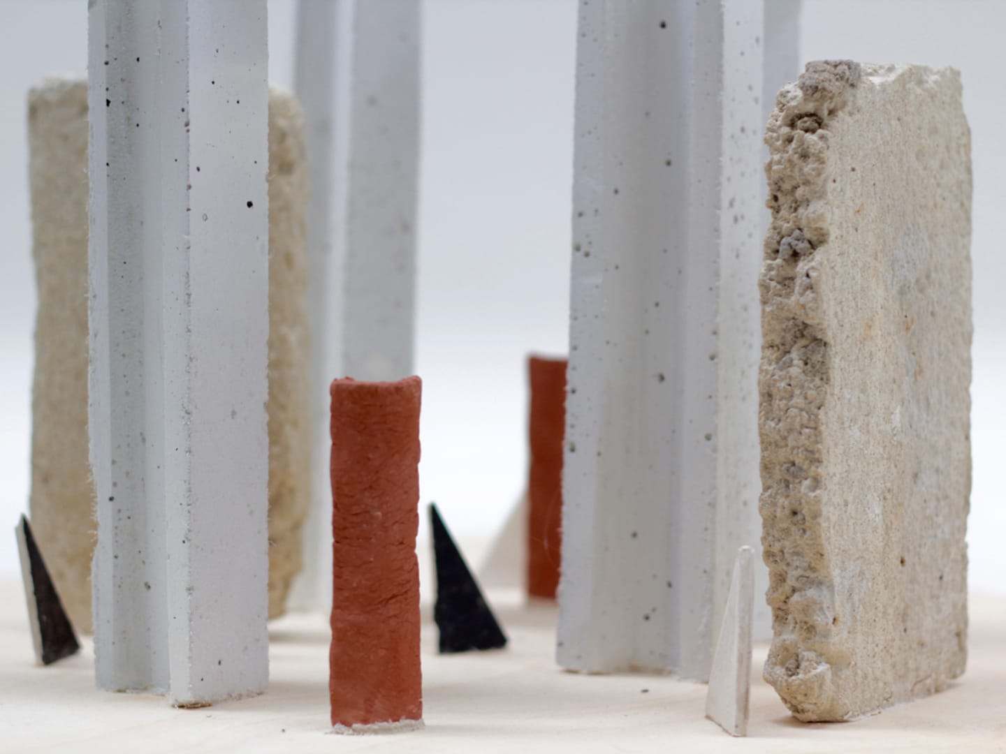 Cast concrete columns with a terracotta and a black element between them