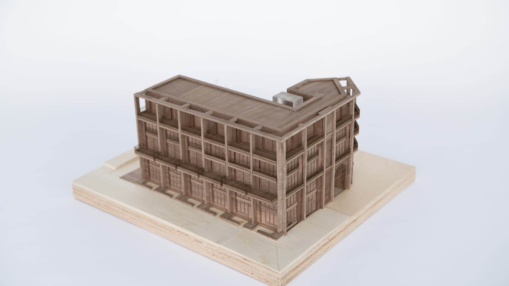 1:100 presentation model in walnut of the Sluisbuurt building, on a light plywood base