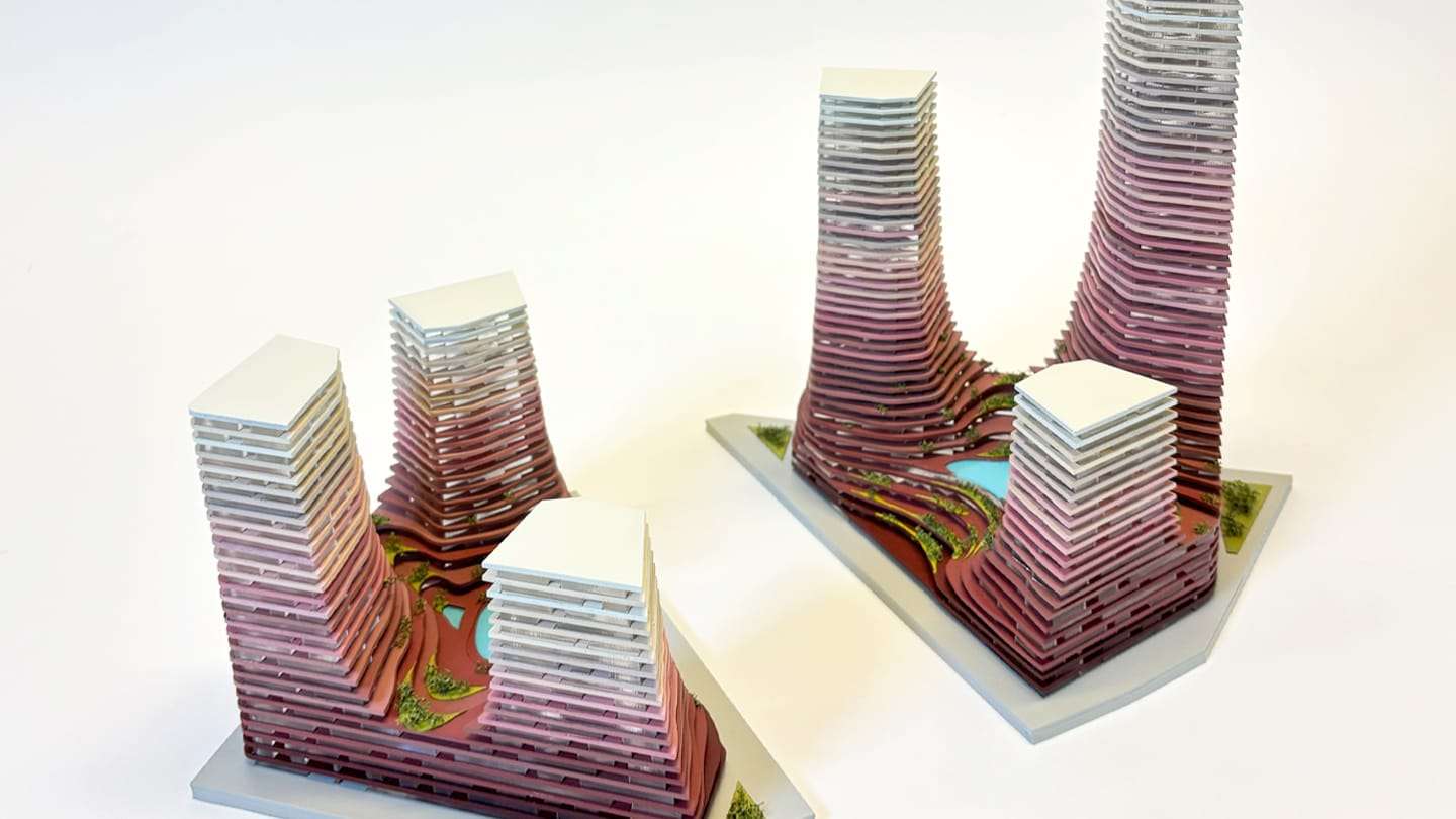 1:300 competition model of the Water Towers: layered towers shading from burgundy to off-white on two white bases
