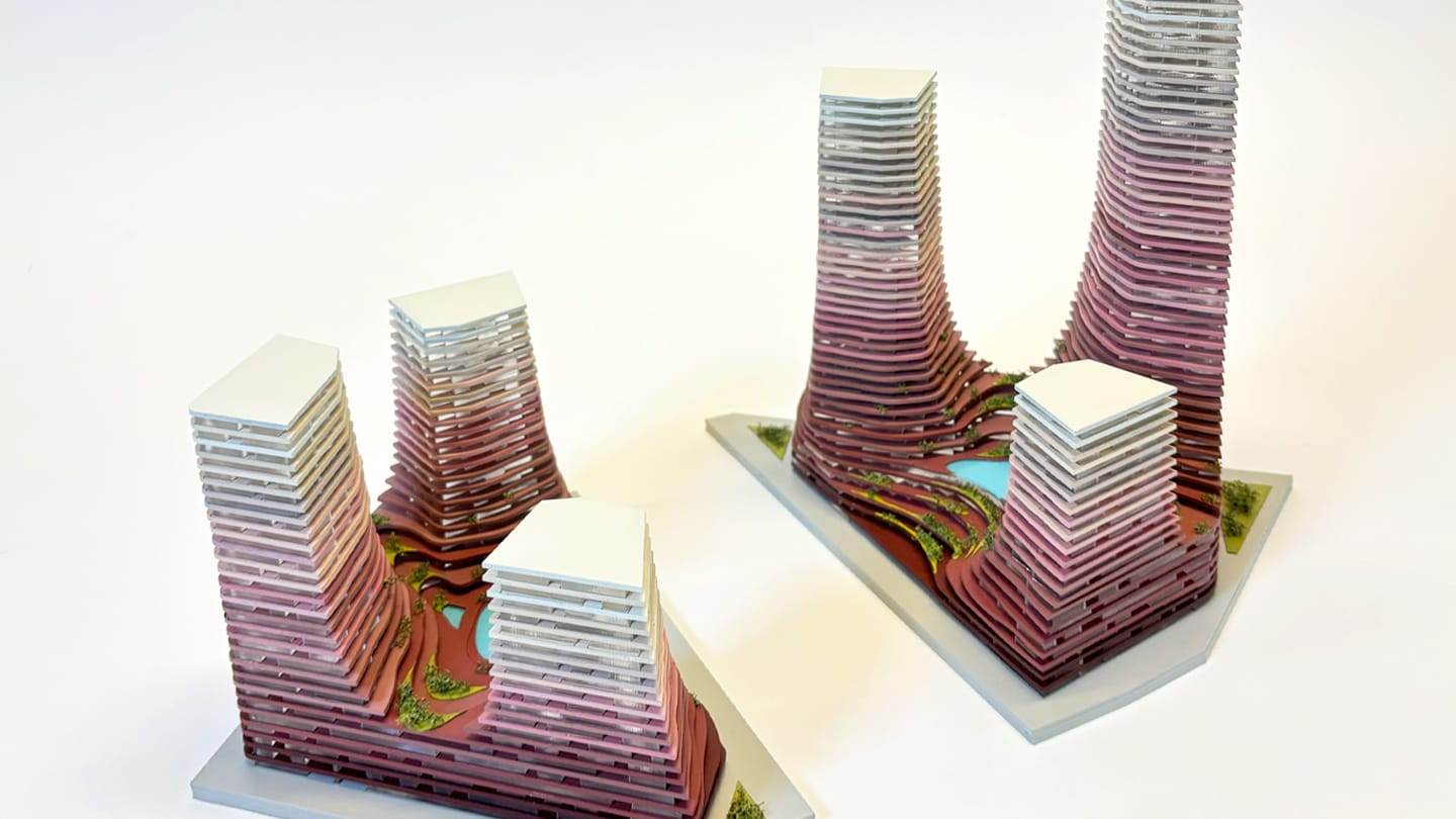 1:300 competition model of the Water Towers: layered towers shading from burgundy to off-white on two white bases