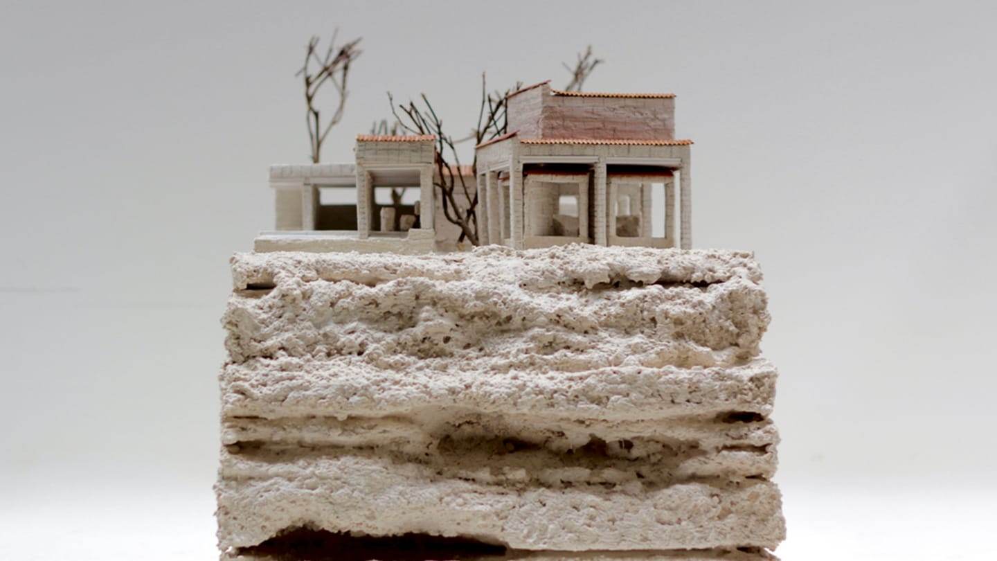 The house standing on the rough, layered stone base