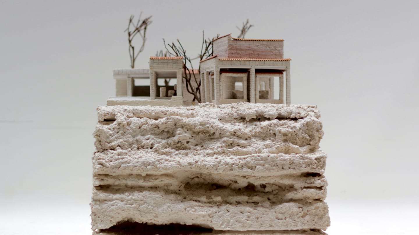 The house standing on the rough, layered stone base