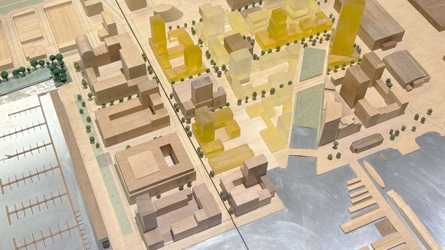 1:1000 model of the NDSM wharf: amber acrylic volumes among timber blocks along the IJ