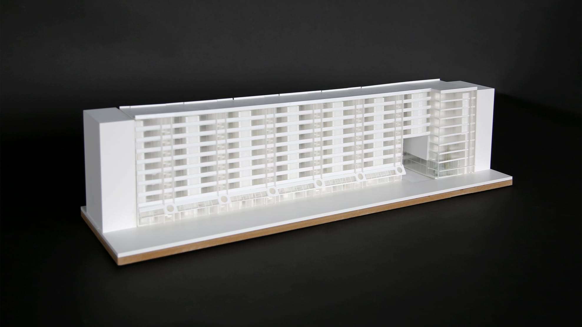 1:200 competition model in white and translucent acrylic, photographed against black