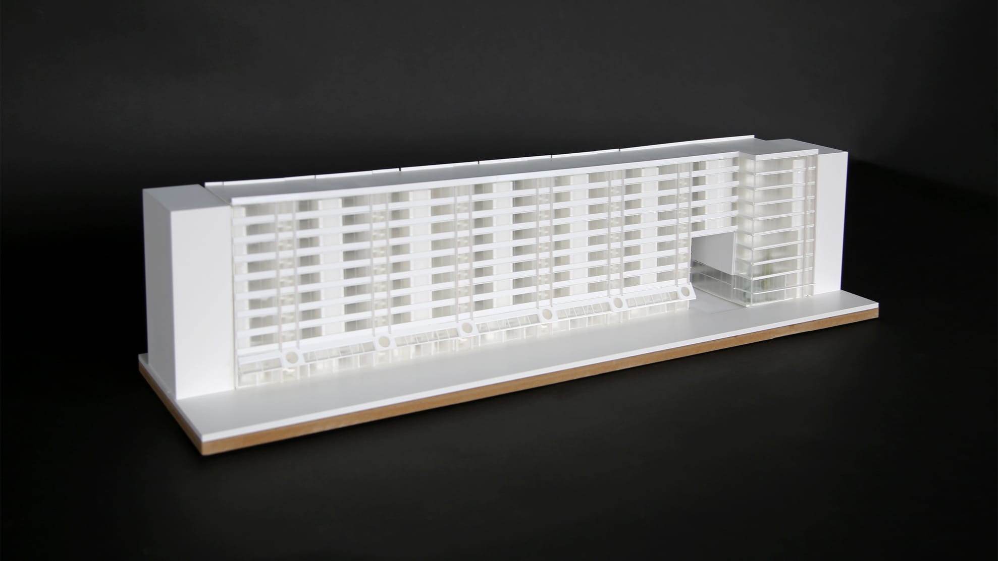 1:200 competition model in white and translucent acrylic, photographed against black