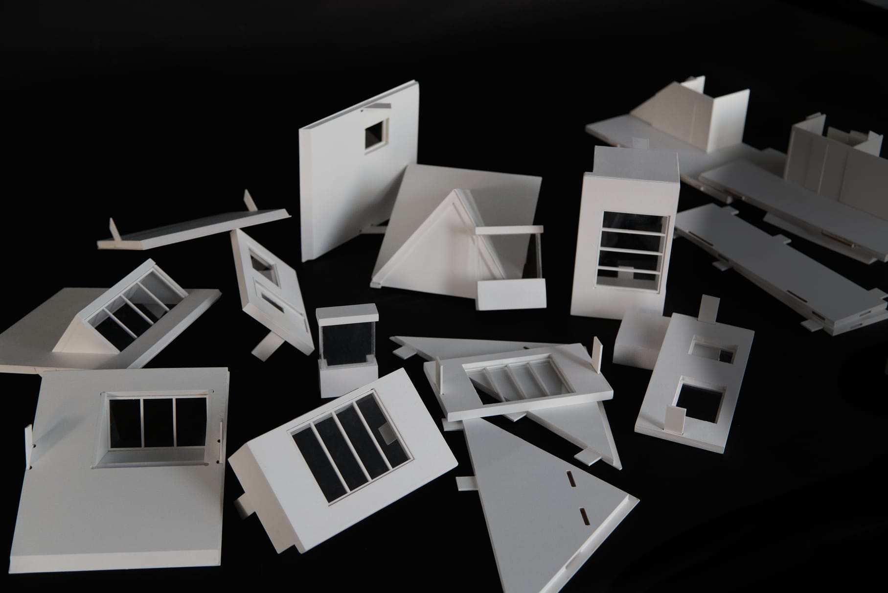 The loose click-in components laid out: walls, roofs, dormers and bay windows