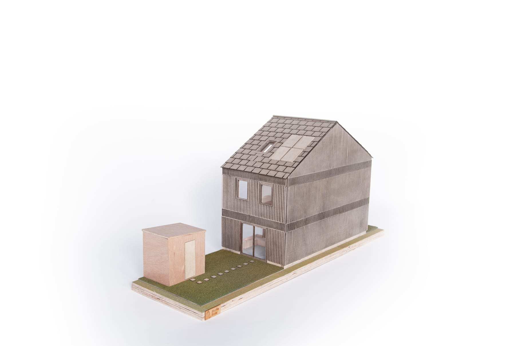 1:30 model of the AER Home: a two-storey timber house with a tiled roof on a grass base