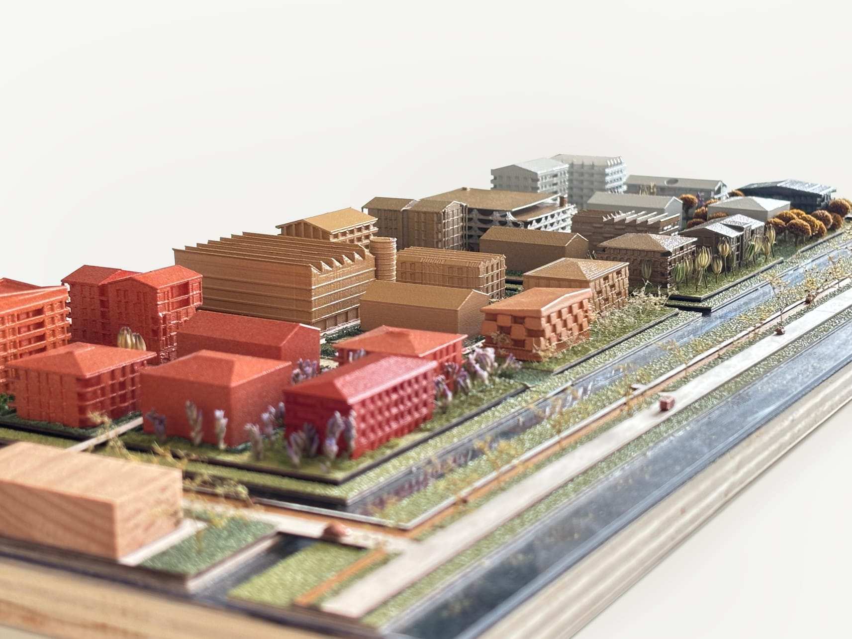 Low view along the canal, with the red blocks in front and the plan behind