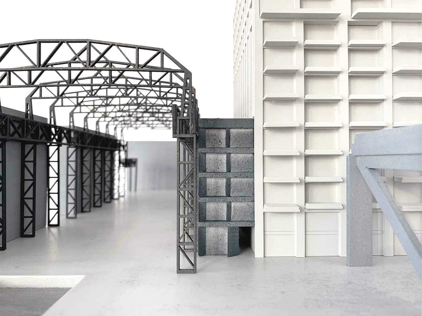 The steel hall structure with the white tower behind it, at eye level