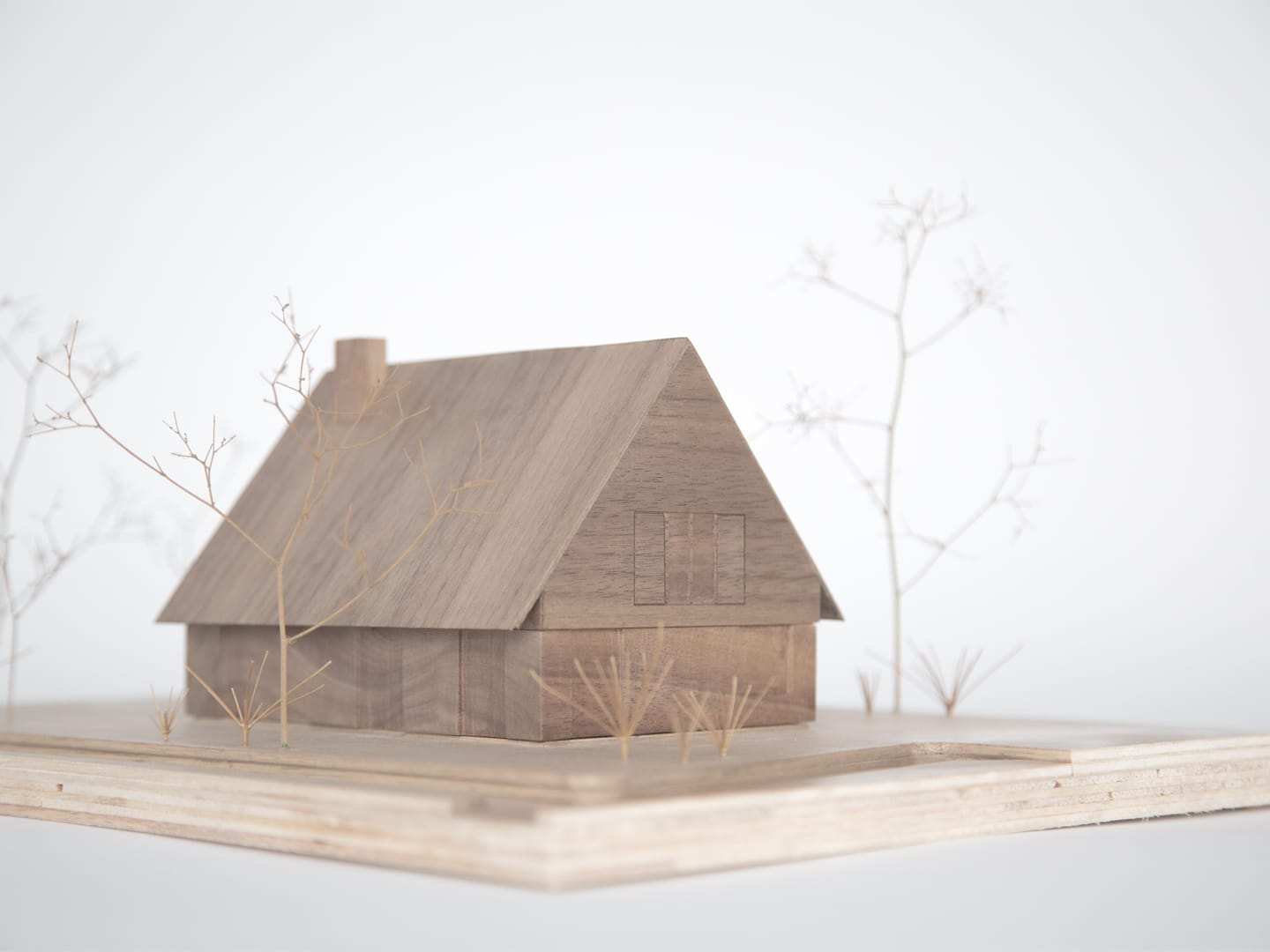 The walnut house with bare branches set into the plywood base